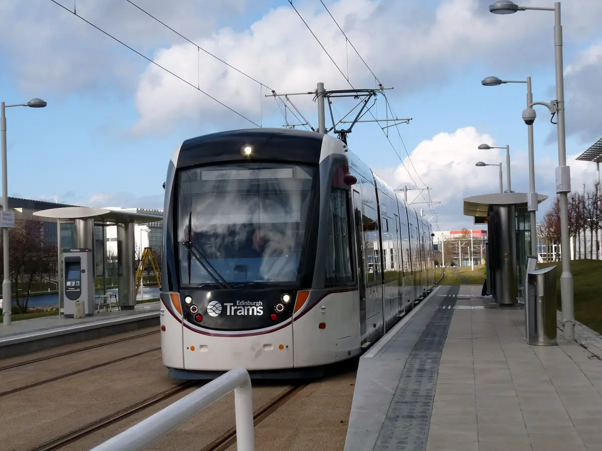 A tram at a stop in Edinburgh
